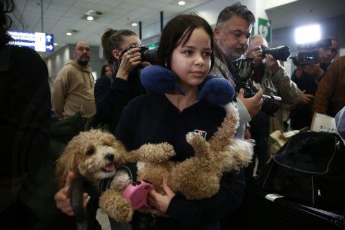 epa12831003 A Greek citizen arrives with her dog after being repatriated on a flight from Abu Dhabi organized by the Greek Ministry of Foreign Affairs at Eleftherios Venizelos Airport in Athens, Greece, 18 March 2026. About 100 Greek nationals were repatriated under the Greek Ministry of Foreign Affairs' special 'Kivotos' operation, which includes the...