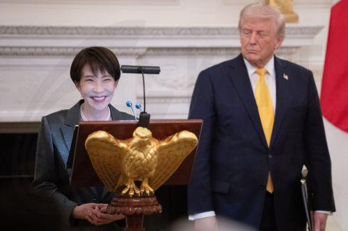 epa12834977 United States President Donald Trump stands with Prime Minster Takeuchi Sanae of Japan as she makes remarks during a bilateral state dinner in the State Dining Room of the White House in Washington DC, USA, 19 March 2026. Earlier in the day, Trump and Takeuchi exchanged views on Iran, energy and issues in the Indo-Pacific region.  EPA/AARON...