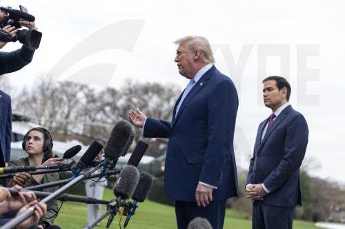 epa12837373 US President Donald J. Trump (C), with Secretary of State Marco Rubio (R), responds to a question from the news media as he walks to board Marine One on the South Lawn of the White House in Washington, DC, USA, 20 March 2026.  EPA/SHAWN THEW / POOL