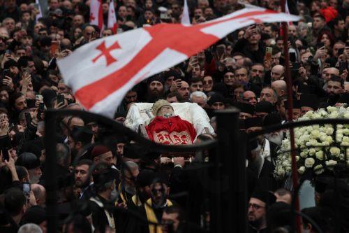 epa12841480 Mourners follow the coffin of the late Georgia's Orthodox Patriarch Ilia II as clergy carry it into the Sioni Cathedral during his funeral ceremony in Tbilisi, Georgia, 22 March 2026. Catholicos-Patriarch Ilia II (Irakli Gudushauri-Shiolashvili) of All Georgia died on 17 March, at the age of 93 in Tbilisi. He had led the Georgian Orthodox Church...