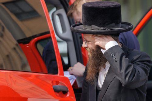 epa12843694 A member of the Jewish community interacts with the firefighters in Antwerp, Belgium, 23 March 2026. The Belgian government announced on 16 March that it will deploy military personnel to reinforce the Federal Police to protect a number of synagogues and Jewish schools across the country following a series of antisemitic attacks in Europe. ...