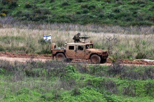 epa12848459 Israeli military vehicles maneuver on the Lebanese side of the border, as seen from the Upper Galilee in northern Israel, 25 March 2026. The Israeli military stated it is conducting strikes across Lebanon targeting Hezbollah infrastructure and personnel.  EPA/ATEF SAFADI