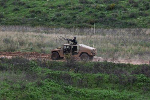 epa12848462 Israeli military vehicles maneuver on the Lebanese side of the border, as seen from the Upper Galilee in northern Israel, 25 March 2026. The Israeli military stated it is conducting strikes across Lebanon targeting Hezbollah infrastructure and personnel.  EPA/ATEF SAFADI