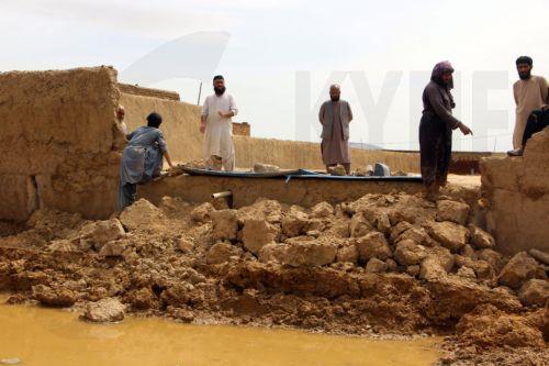 epa12851043 Residents inspect damaged belongings after heavy rains in Kandahar, Afghanistan, 26 March 2026. At least ten people died and  six others were injured, while dozens of homes were destroyed and thousands of acres of farmland were severely damaged due to heavy rains and flooding in Kandahar and Helmand, according to Afghan officials. ...