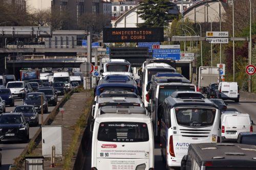 epa12859828 Truck and bus drivers stage a slowdown on the city’s ring road to protest against the rising fuel prices in Paris, France, 30 March 2026.  EPA/YOAN VALAT