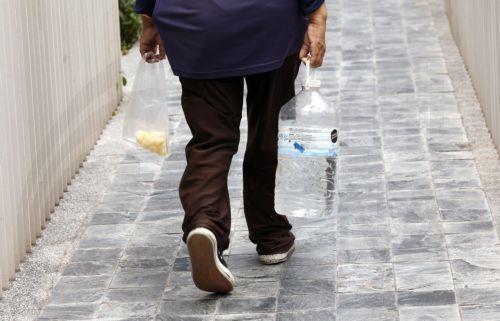 epa12859931 An outdoor female worker carries a bottle of drinking water and fresh fruit during hot weather in Bangkok, Thailand, 30 March 2026. The Meteorological Department reports that Thailand is experiencing extreme heat and urges the public to avoid outdoor activity while the Digital Economy and Society Ministry warns the country's heat index is...
