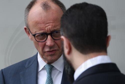 epa12860007 German Chancellor Friedrich Merz (L) and Syrian President Ahmed al-Sharaa (R) chat on the terrace of the Chancellery prior to talks in Berlin, Germany, 30 March 2026. The Syrian president is on his first official state visit to Germany.  EPA/SEAN GALLUP / POOL