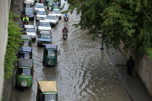 epa12860016 Vehicles drive along a flooded road during heavy rain in Peshawar, Pakistan, 30 March 2026. At least nine people were killed and several others injured after heavy rains and strong winds caused roof collapses in parts of Khyber Pakhtunkhwa and Punjab, with Bannu among the worst affected. Rescue efforts are ongoing, and authorities have warned of...