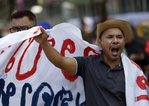 epa12865756 A protester shouts slogans during a demonstration against the soaring fuel prices and living costs, outside Government House, in Bangkok, Thailand, 02 April 2026. Labor networks and civil society groups staged the protest against oil price hikes, urging the government to address the energy crisis and its direct impact on the cost of living. ...