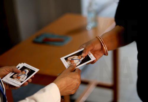 epa12866796 A nun distributes picture cards of Mother Teresa during Good Friday at Mother House in Kolkata, India, 03 April 2026. Good Friday is a religious holiday observed primarily by adherents to Christianity commemorating the crucifixion of Jesus and his death at Golgotha. The holiday is observed during Holy Week as part of the Paschal Triduum on the...