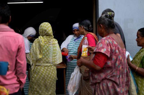 epa12866798 People receive food donations during Good Friday near Mother House in Kolkata, India, 03 April 2026. Good Friday is a religious holiday observed primarily by adherents to Christianity commemorating the crucifixion of Jesus and his death at Golgotha. The holiday is observed during Holy Week as part of the Paschal Triduum on the Friday preceding...