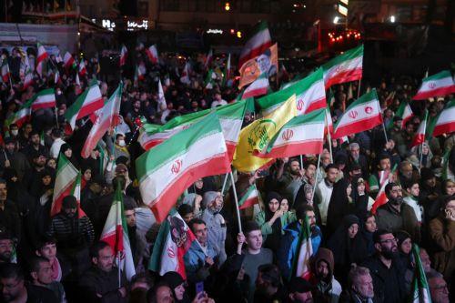 epa12874348 Iranians wave flags during a demonstration following the announcement of a two-week ceasefire at Enghelab Square in Tehran, Iran, 08 April 2026. Iran and the USA agreed to the two-week truce to halt military operations and keep the Strait of Hormuz open for oil and gas shipments, with formal peace talks set to begin in Islamabad on 10 April. ...