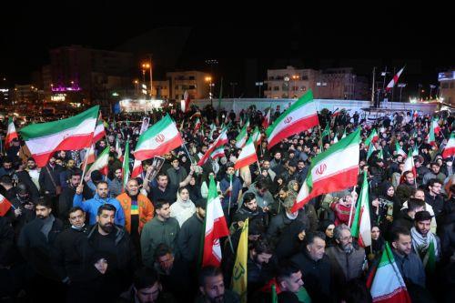 epa12874355 Iranians wave flags during a demonstration following the announcement of a two-week ceasefire at Enghelab Square in Tehran, Iran, 08 April 2026. Iran and the USA agreed to the two-week truce to halt military operations and keep the Strait of Hormuz open for oil and gas shipments, with formal peace talks set to begin in Islamabad on 10 April. ...