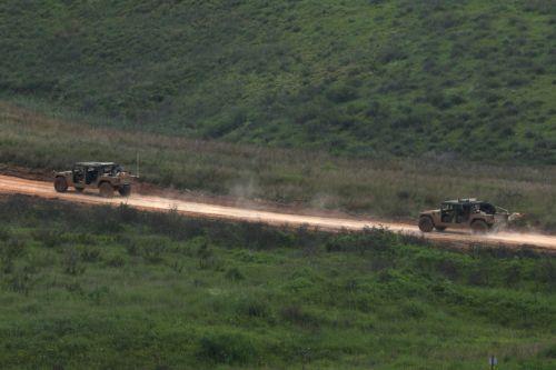 epa12877164 Israeli military vehicles drive on the Lebanese side of the border, as seen from the upper Galilee on the Israel-Lebanon border, 09 April 2026. The Israeli military said it continued targeting operations of Hezbollah in southern Lebanon.  EPA/ATEF SAFADI