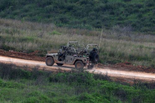 epa12877167 An Israeli military vehicle passes on the Lebanese side of the border, as seen from the upper Galilee on the Israel-Lebanon border, 09 April 2026. The Israeli military said it continued targeting operations of Hezbollah in southern Lebanon.  EPA/ATEF SAFADI