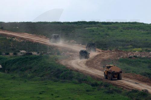 epa12877169 Israeli military vehicles drive on the Lebanese side of the border, as seen from the upper Galilee on the Israel-Lebanon border, 09 April 2026. The Israeli military said it continued targeting operations of Hezbollah in southern Lebanon.  EPA/ATEF SAFADI