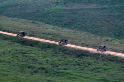 epa12877173 Israeli military vehicles drive on the Lebanese side of the border, as seen from the upper Galilee on the Israel-Lebanon border, 09 April 2026. The Israeli military said it continued targeting operations of Hezbollah in southern Lebanon.  EPA/ATEF SAFADI