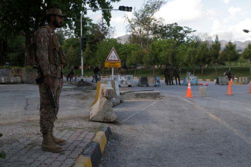 epa12877625 Pakistani security officials stand guard at a checkpoint as security has been intensified ahead of the visit of US and Iranian delegations in Islamabad, Pakistan, 09 April 2026. Prime Minister Shehbaz Sharif said US and Iranian delegations will visit Islamabad for peace talks following a Middle East ceasefire, with Iranian President Masoud...