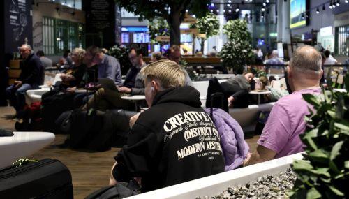 epa12879833 Passengers wait in Terminal 1 during a strike at the international airport at Frankfurt Airport, in Frankfurt am Main, Germany, 10 April 2026. The UFO cabin crew union has called on its members to strike, to press their demands for better wages.  EPA/RONALD WITTEK