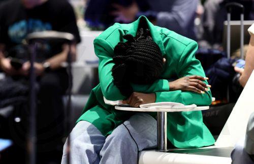 epa12879834 Passengers wait in Terminal 1 during a strike at the international airport at Frankfurt Airport, in Frankfurt am Main, Germany, 10 April 2026. The UFO cabin crew union has called on its members to strike, to press their demands for better wages.  EPA/RONALD WITTEK