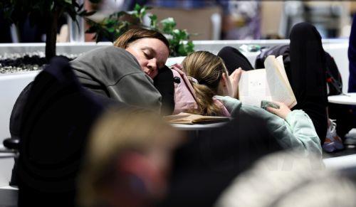 epa12879836 Passengers wait in Terminal 1 during a strike at the international airport at Frankfurt Airport, in Frankfurt am Main, Germany, 10 April 2026. The UFO cabin crew union has called on its members to strike, to press their demands for better wages.  EPA/RONALD WITTEK