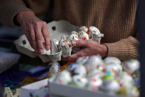 epa12880098 A vendor packs hand-painted Easter eggs for sale at a farmers market in Belgrade, Serbia, 10 April 2026. Orthodox Serbs will celebrate Easter on 12 April 2026.  EPA/ANDREJ CUKIC