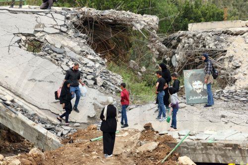 epaselect epa12900340 Displaced people walk across a destroyed bridge as they return to their villages, in the village of Tayr Felsay, in southern Lebanon, 19 April 2026. Israel and Lebanon have agreed to a 10-day ceasefire, which went into effect at midnight on 16 April.  EPA/WAEL HAMZEH