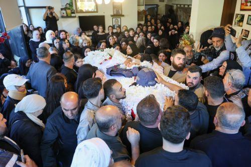 epa12909563 People mourn as they gather around the coffin of Lebanese journalist Amal Khalil during her funeral procession in the village of Baisariyah, southern Lebanon, 23 April 2026. Al-Akhbar newspaper journalist Amal Khalil was killed on 22 April after an Israeli airstrike targeted a building in the village of al-Tiri, Bint Jbeil district, in southern...