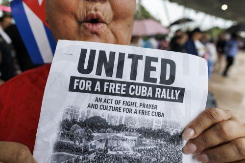 epaselect epa12916198 A participant holds a sign during the Save Cuba rally in Miami, Florida, USA, 26 April 2026. Save Cuba is a rally organized by Miami's Cuban community to call for a political transition in Cuba.  EPA/CRISTOBAL HERRERA-ULASHKEVICH