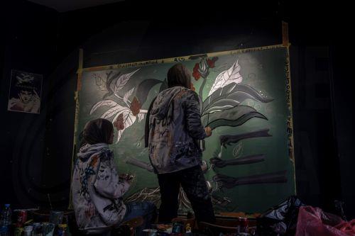 epa12922465 Palestinian Joud Mohammed (R), 18, and Rahaf Al-Halabi (L), 18, paint together inside a small cafe in Gaza City, 29 April 2026. The two teenagers use their artwork as a means of self-expression and to provide financial support for their families amid ongoing economic hardship. With Gaza's educational system largely paralyzed since the outbreak...
