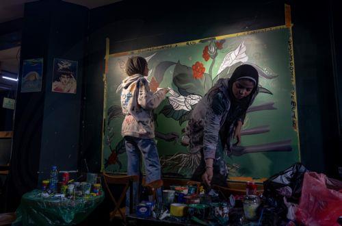epaselect epa12922460 Palestinian Joud Mohammed (R), 18, and Rahaf Al-Halabi (L), 18, paint together inside a small cafe in Gaza City, 29 April 2026. The two teenagers use their artwork as a means of self-expression and to provide financial support for their families amid ongoing economic hardship. With Gaza's educational system largely paralyzed since the...