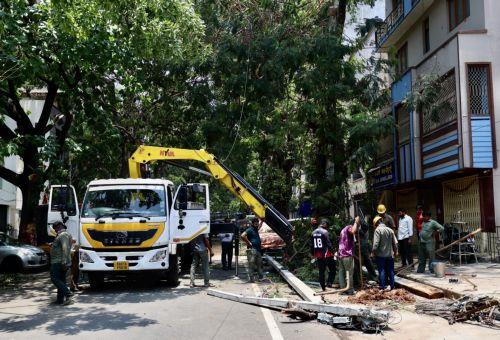 epa12923712 Members of the Bangalore Electricity Supply Company Limited (BESCOM) work on a broken electric pole following heavy overnight rain in Bangalore, India, 30 April 2026. The city was affected by over 111.5 mm of rainfall and strong winds on 29 April. More than 170 trees were uprooted, and many branches were broken due to lightning and...