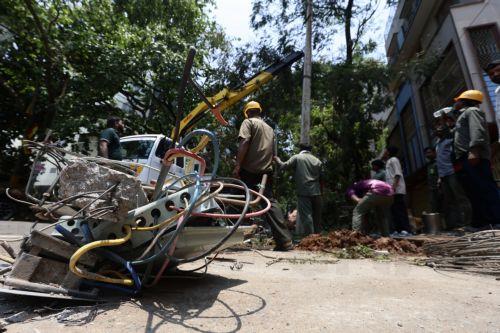 epa12923713 Members of the Bangalore Electricity Supply Company Limited (BESCOM) work on a broken electric pole following heavy overnight rain in Bangalore, India, 30 April 2026. The city was affected by over 111.5 mm of rainfall and strong winds on 29 April. More than 170 trees were uprooted, and many branches were broken due to lightning and...