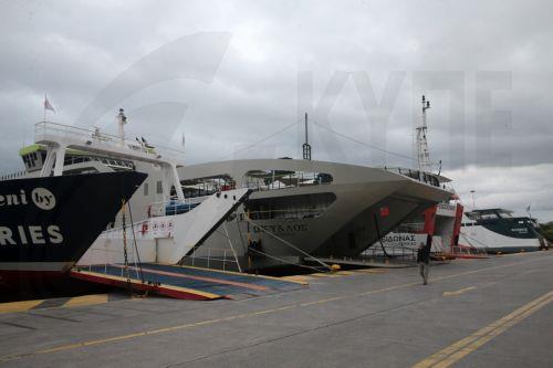epa12926125 A man walks at the harbor past docked ferries during a 24-hour general strike marking the International Labor Day in the port of Piraeus near Athens, Greece, on 01 May 2026. Public transport workers participate in the strikes taking place on May 1, demanding collective agreements with real wage increases, the recruitment of permanent staff to...