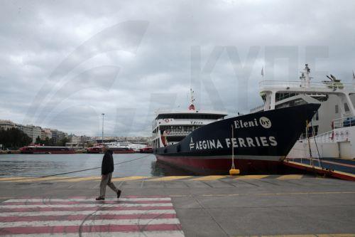 epa12926129 A man walks at the harbor past docked ferries during a 24-hour general strike marking the International Labor Day in the port of Piraeus near Athens, Greece, on 01 May 2026. Public transport workers participate in the strikes taking place on May 1, demanding collective agreements with real wage increases, the recruitment of permanent staff to...