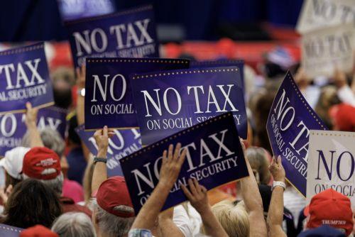 epa12927379 Supporters of US President Donald Trump hold up signs that read 'No Tax on Social Security' during an event with seniors in The Villages, Florida, USA, 01 May 2026. Trump outlined tax proposals for retirees, including a senior deduction aimed at reducing taxes on Social Security benefits and other retirement-related measures.  EPA/CRISTOBAL...