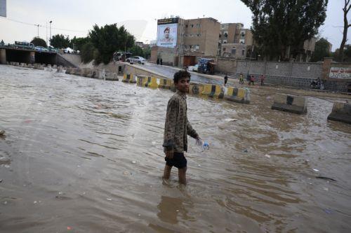 epa12929033 A person wades through a flooded street following torrential rainfall in Sana'a, Yemen, 02 May 2026. Yemen's National Center of Meteorology and Early Warning has warned of further heavy rains and possible flooding across much of the country.  EPA/YAHYA ARHAB