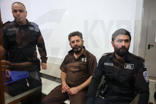 epa12929417 Saif Abu Keshek (C), a member of the Global Sumud Flotilla, arrives to attend his trial for a remand extension at the Ashkelon Magistrate's Court in Ashkelon, Israel, 03 May 2026. Abu Keshek along with Thiago Avila were arrested on 02 May off the island of Crete, according to the organization. According to the Israeli Ministry of Foreign...
