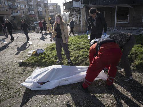 epa12935000 GRAPHIC CONTENT - A handout photo made available by the press service of the 93rd Kholodnyi Yar Separate Mechanized Brigade of Ukrainian Armed Forces shows people covering a body in the aftermath of a Russian airstrike in Kramatorsk, Donetsk region, Ukraine, 05 May 2026, amid the ongoing Russian invasion. Several people died and a dozens were...