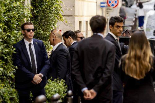 epa12938750 US Secretary of State Marco Rubio is escorted by security as he arrives at his hotel in Rome, Italy, 07 May 2026. Rubio is in the Italian capital for high-level meetings with Vatican and Italian officials.  EPA/MASSIMO PERCOSSI