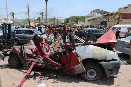 epa12952891 Lebanese rescuers and army soldiers inspect the wreckage of a vehicle that was hit in an Israeli strike in the southern coastal city of Sidon, Lebanon, 13 May 2026.  EPA/WAEL HAMZEH