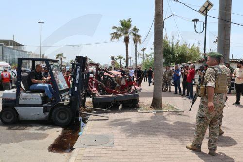 epa12952893 Lebanese rescuers and army soldiers inspect the wreckage of a vehicle that was hit in an Israeli strike in the southern coastal city of Sidon, Lebanon, 13 May 2026.  EPA/WAEL HAMZEH