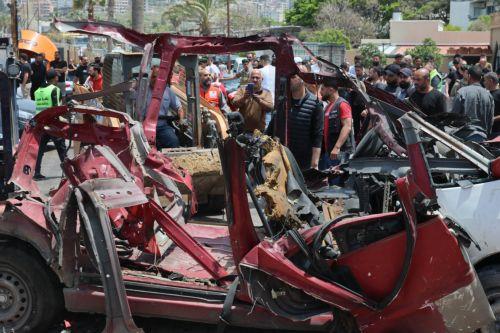 epa12952894 Lebanese rescuers and army soldiers inspect the wreckage of a vehicle that was hit in an Israeli strike in the southern coastal city of Sidon, Lebanon, 13 May 2026.  EPA/WAEL HAMZEH
