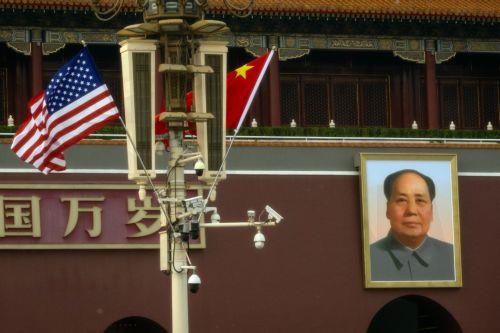 epa12952917 US (L) and Chinese flags flutter next to a portrait of Chinese communist leader and founder of the People's Republic of China Mao Zedong at Tiananmen Square, in Beijing, China, 13 May 2026. US President Donald Trump is due to arrive in Beijing for a high-stakes state visit running through 15 May, marking his first return to the mainland since...