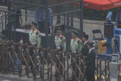 epa12958691 Security stand on guard after US President Donald Trump's motorcade leaves the hotel and drives to the airport, in Beijing, China, 15 May 2026. US President Trump flew to Beijing for a high-stakes state visit running 13 May through 15 May, marking his first return to the mainland since 2017.  EPA/JESSICA LEE