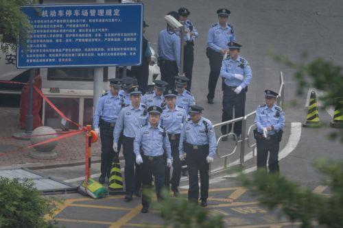 epa12958693 Police walk on the street before US President Donald Trump's motorcade leaves the hotel and drives to the airport, in Beijing, China, 15 May 2026. US President Trump flew to Beijing for a high-stakes state visit running 13 May through 15 May, marking his first return to the mainland since 2017.  EPA/JESSICA LEE