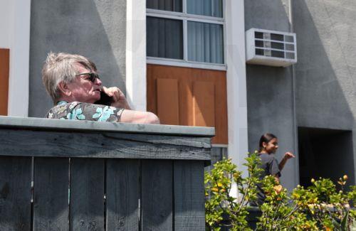 epa12972645 Vincent Higinbotham watches the action on Clairemont Avenue across from the Islamic Center after the active shooting incident in San Diego, California, USA, 18 May 2026. Police agencies from across San Diego County responded to an active shooter incident at the Islamic Center of San Diego in the Clairemont neighborhood. Three people were killed,...