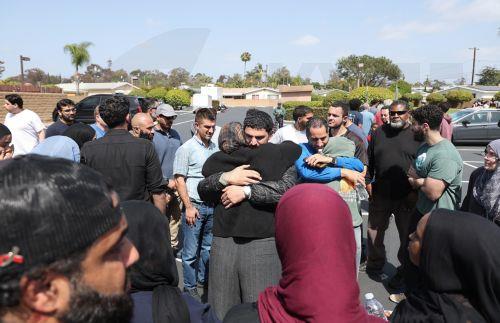epa12972652 Members of the Islamic Center of San Diego embrace each other after learning news about a shooting at their house of worship in San Diego, California, USA, 18 May 2026. Police agencies from across San Diego County responded to an active shooter incident at the Islamic Center of San Diego in the Clairemont neighborhood. Three people were killed,...