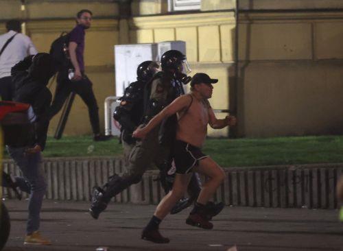 epa12988414 Riot police officers chase a protestor after a mass student-led anti-government rally in Belgrade, Serbia, 23 May 2026. Thousands gathered to ramp up pressure on the government and demand early parliamentary elections. The political movement originally erupted across the country following the November 2024 canopy collapse at the Novi Sad railway...