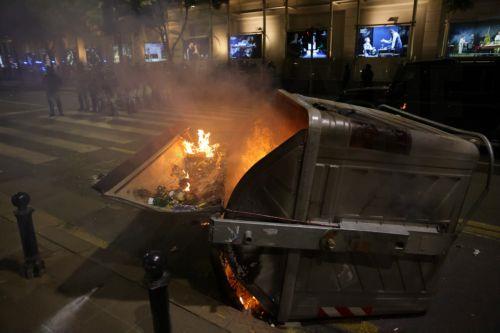 epaselect epa12988491 An overturned dumpster burns as riot police officers take positions after a mass student-led anti-government rally in Belgrade, Serbia, 23 May 2026. Thousands gathered to ramp up pressure on the government and demand early parliamentary elections. The political movement originally erupted across the country following the November 2024...